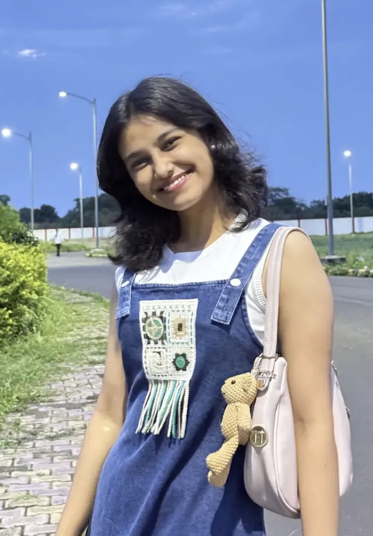 Portrait of Khushi Shinde smiling outdoors at dusk